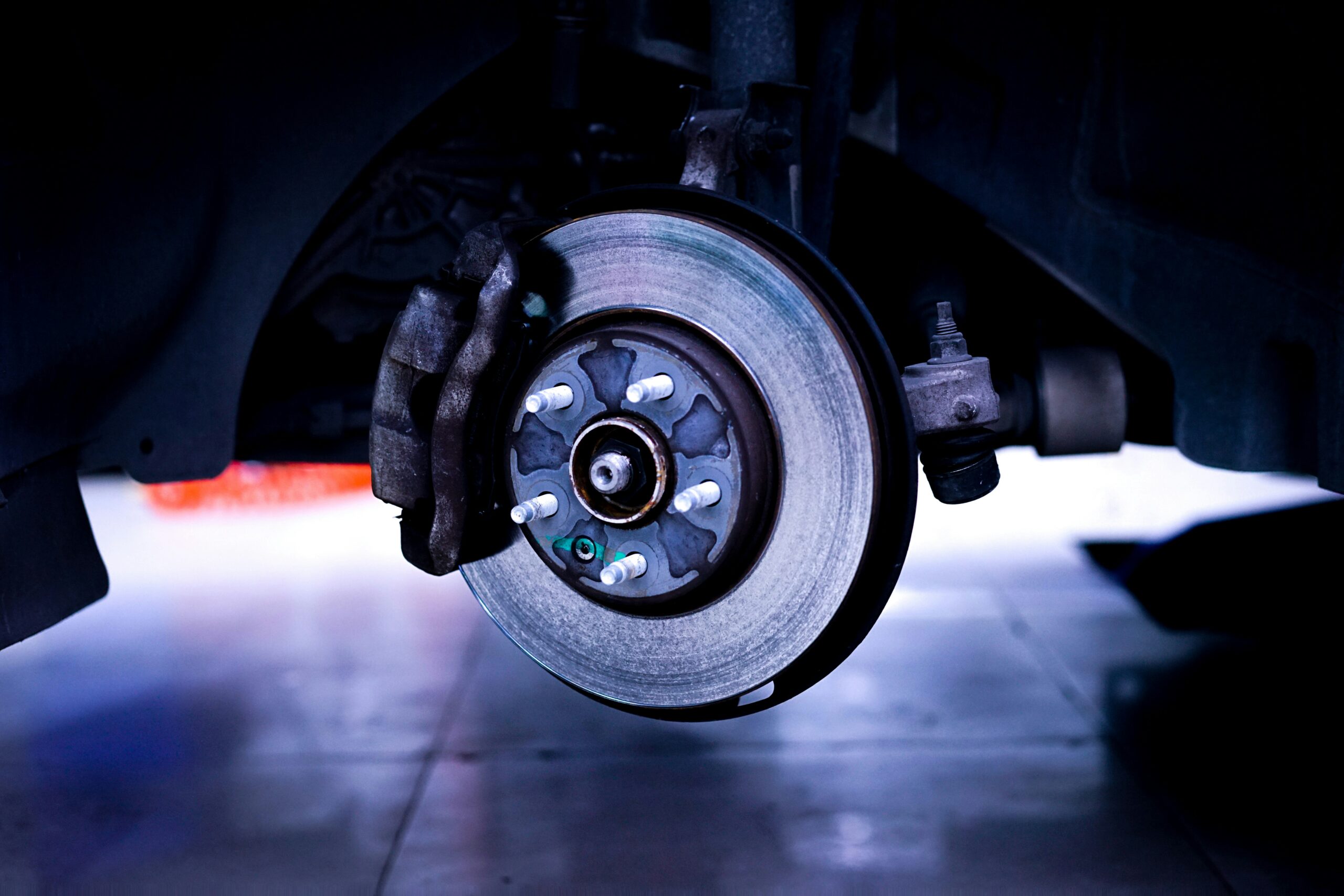 a close up of a car brake pads and rotors