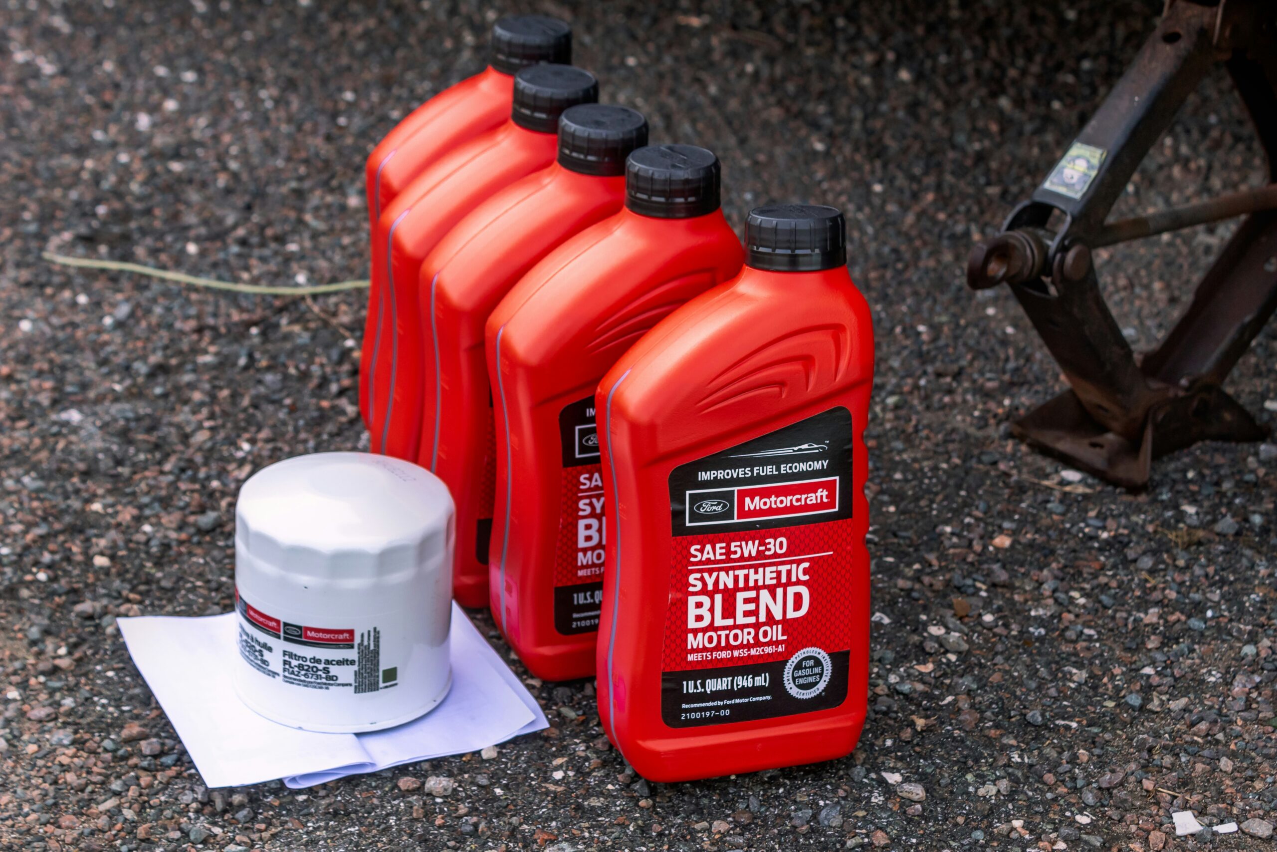 a few bottles of motor oil sitting on the ground